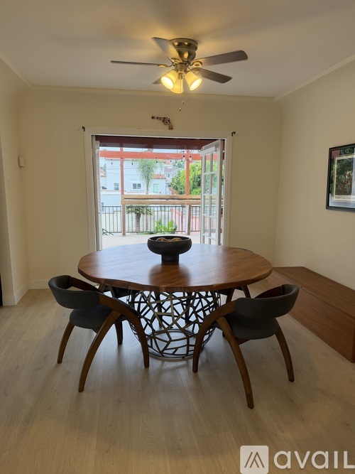 A dining room with a round table and chairs.
