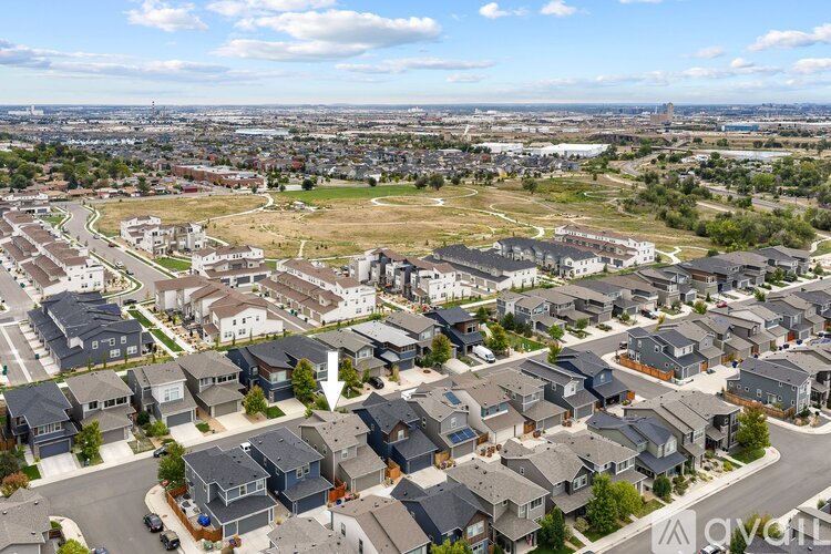 A bird's eye view of a residential area with houses and roads.