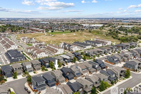 A bird's eye view of a residential area with houses and roads.