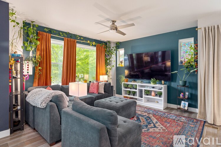 A living room with grey couches and a television.
