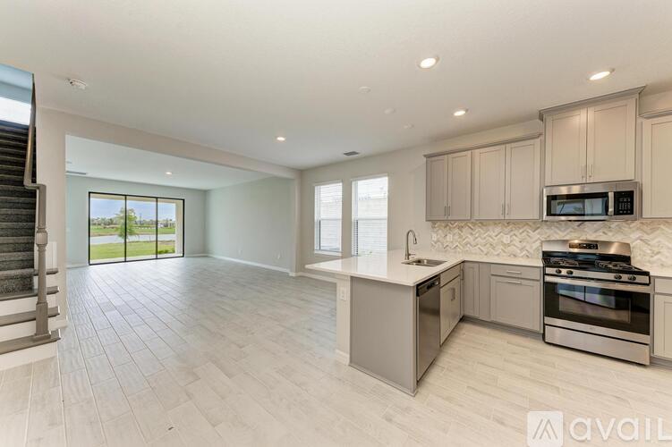 A modern kitchen with a stainless steel oven and microwave.