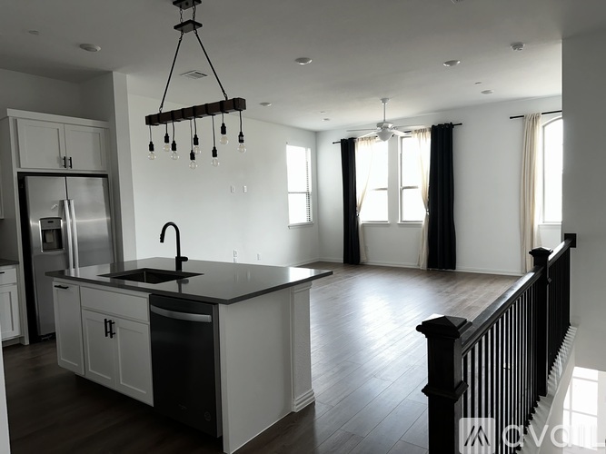 A modern kitchen with a black and white color scheme.