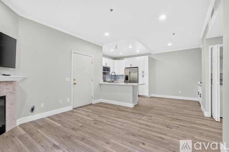 A spacious living room with a fireplace and a television.