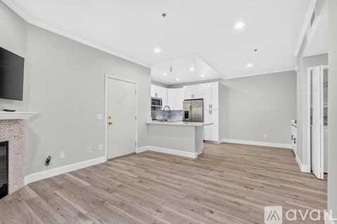 A spacious living room with a fireplace and a television.