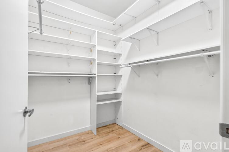 A white room with a wooden floor and white walls.
