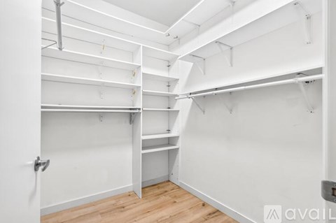A white room with a wooden floor and white walls.