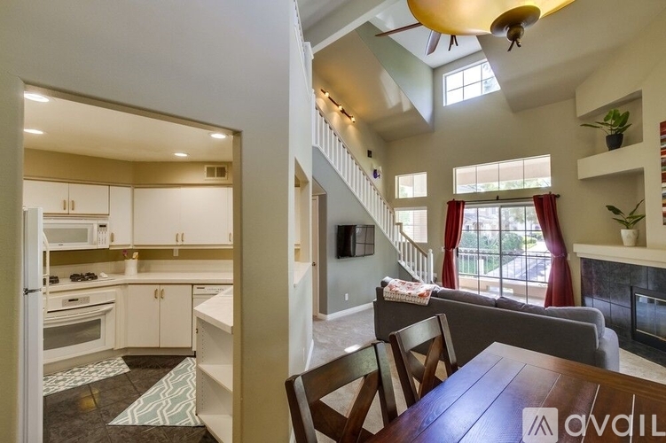 A modern kitchen with a dining table and chairs.