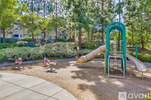 A playground with a green slide and a yellow slide.