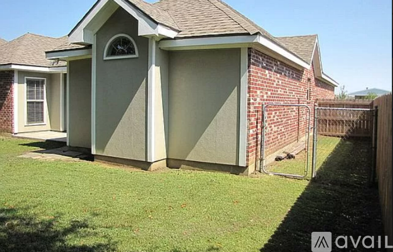 A house with a grey and beige exterior is shown.