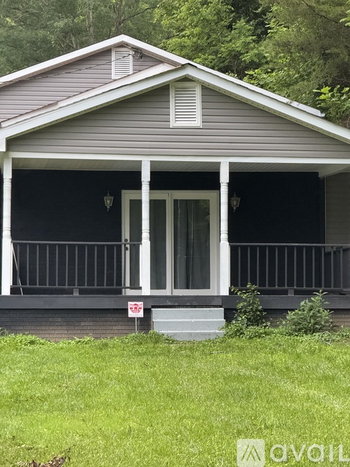 A house with a porch and a white door.