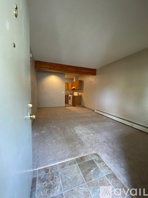 A room with a tiled floor and a door on the left.