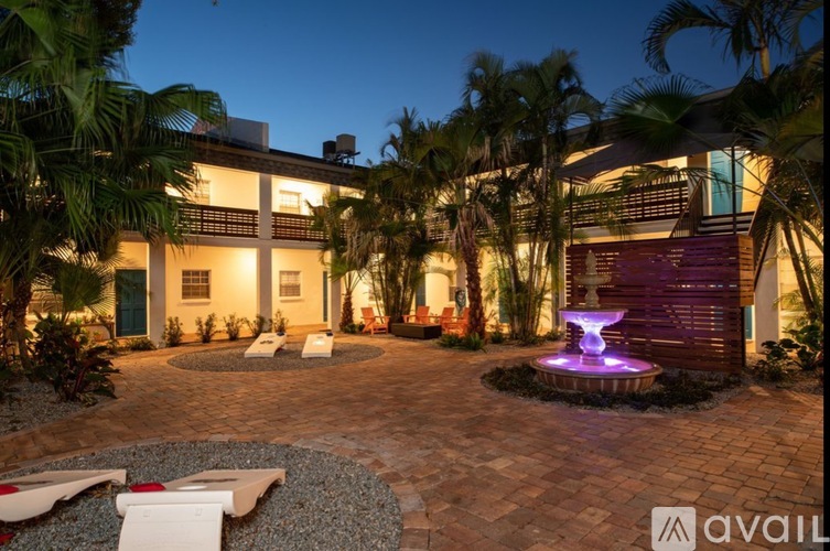 A house with a fountain in the front yard.