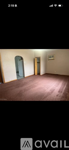A room with a brown floor and a white door.