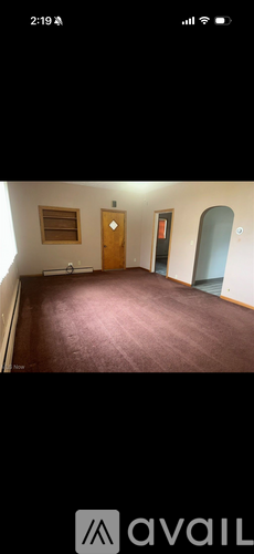 A room with a wooden door and a window.