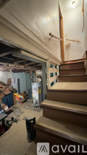A staircase in a building under renovation with boxes and construction materials around.