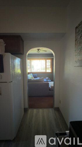 A living room with a couch and a window.