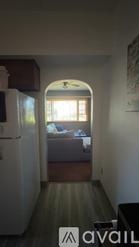 A living room with a couch and a window.