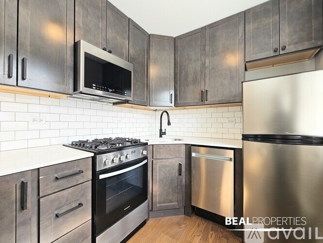 A kitchen with a stove, oven, and microwave.