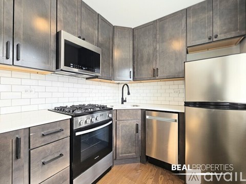 A kitchen with a stove, oven, and microwave.