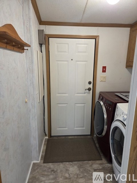 A small laundry room with a washer and dryer.