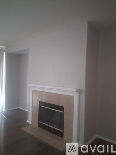 A fireplace in a room with a wooden floor.