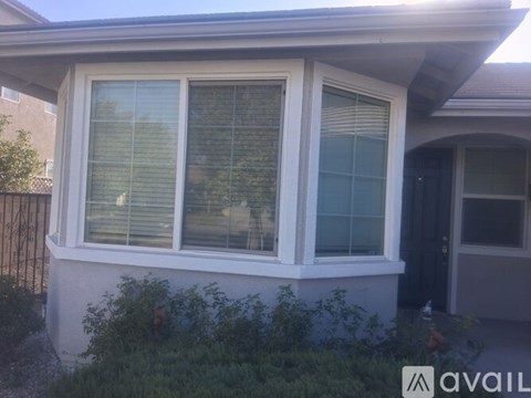 A house with a white window and a black door.