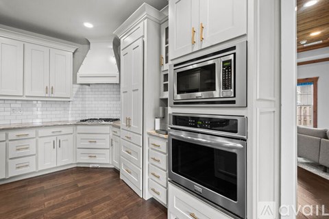 A kitchen with white cabinets and stainless steel appliances.