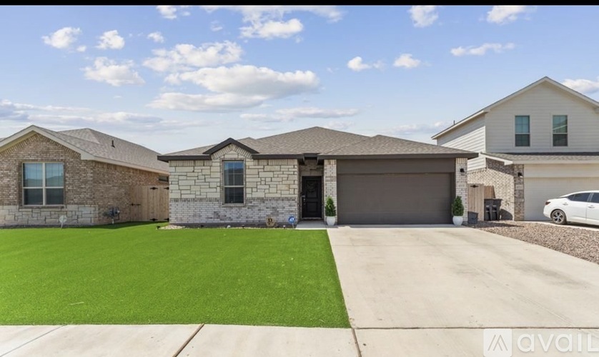 A house with a garage and a car parked in front.