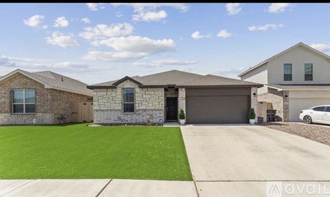A house with a garage and a car parked in front.