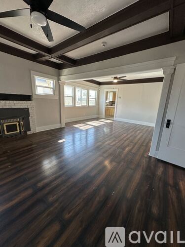 A room with wooden floors and a fireplace.