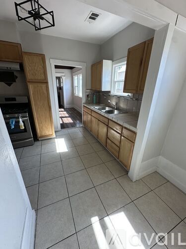 A kitchen with wooden cabinets and a white refrigerator.