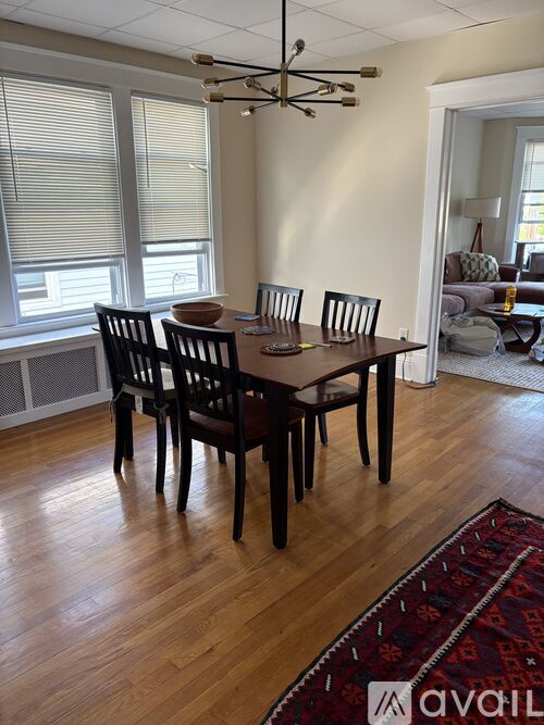 A dining room with a table and chairs.