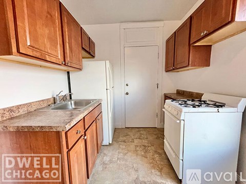 A kitchen with a white stove and wooden cabinets.