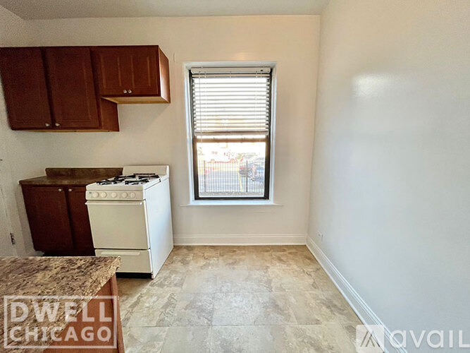 A kitchen area with a stove and cabinets.