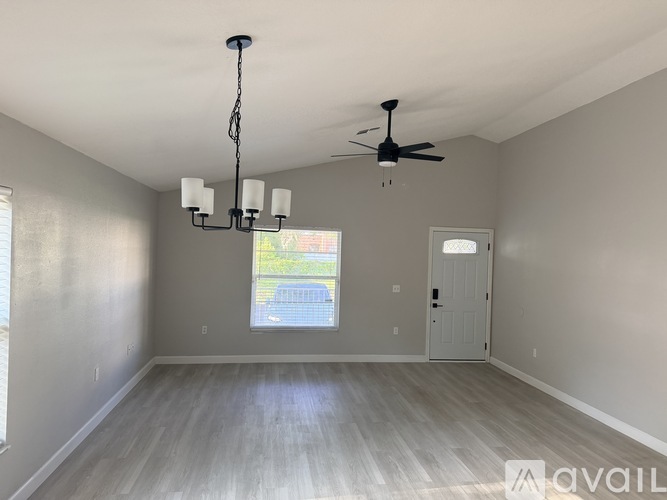 A room with a ceiling fan and a chandelier.