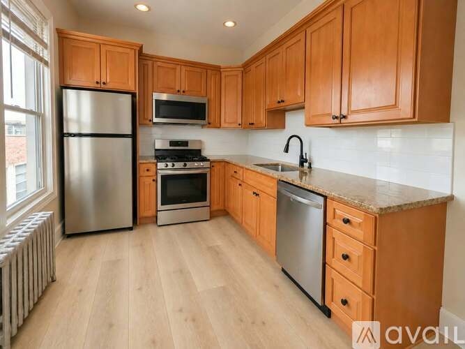 A kitchen with wooden cabinets and stainless steel appliances.