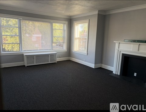 A room with grey walls and a fireplace.