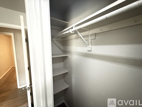 A white refrigerator with a white pipe on top of it.