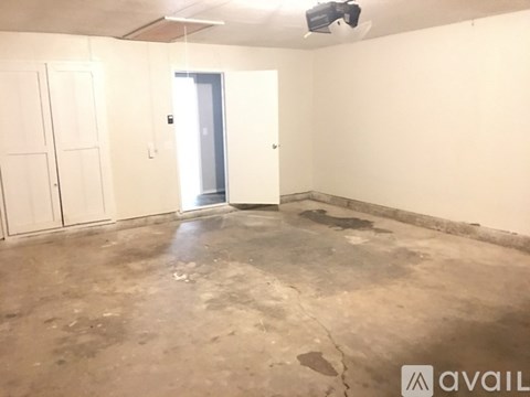 A room with a concrete floor and white walls.