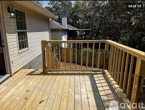 A wooden deck is being built in front of a house.