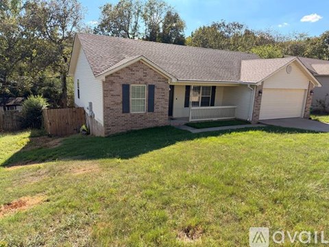A house with a white exterior and a grey roof is for sale.