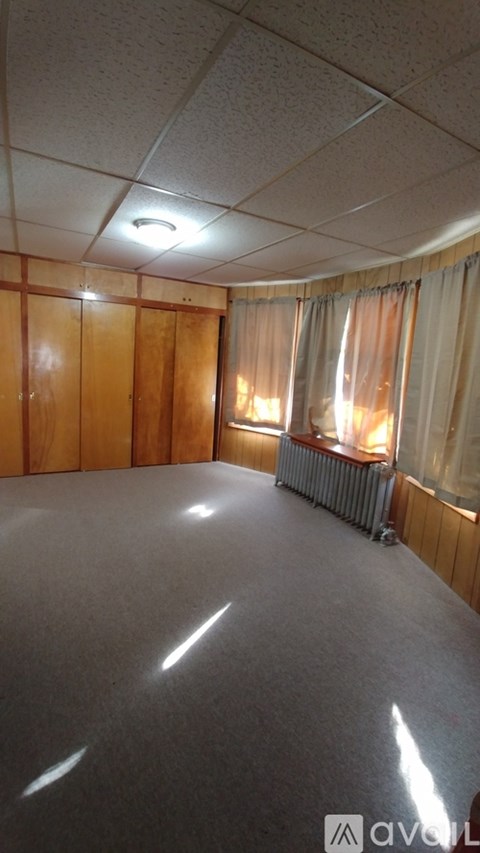 A room with wooden walls and a radiator.
