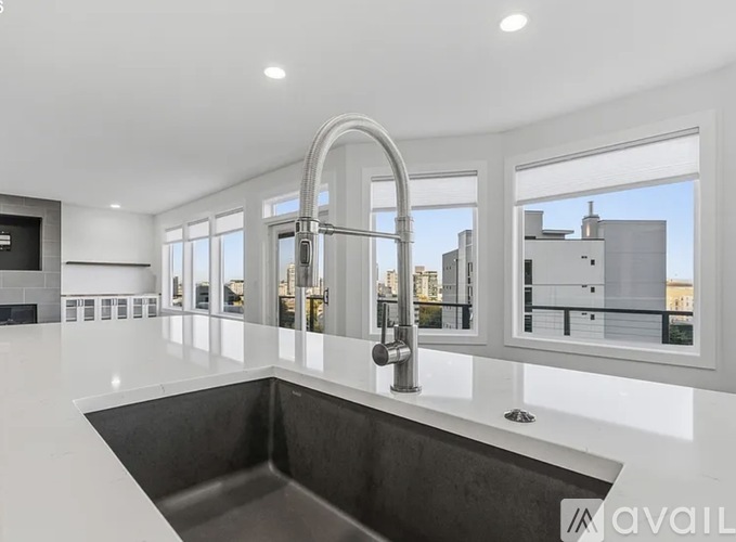 A modern kitchen with a large window overlooking the city.