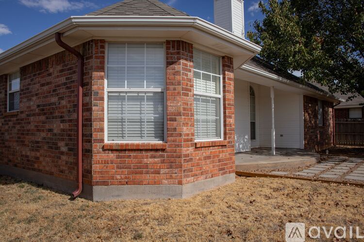 A house with a brick exterior and a white door is for sale.