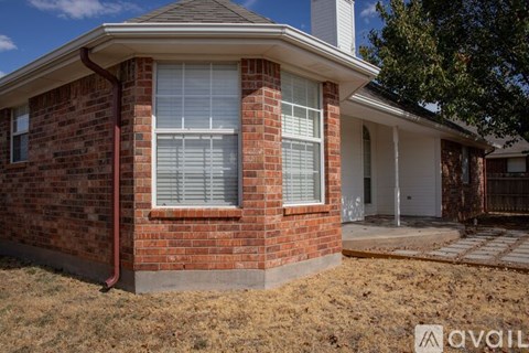 A house with a brick exterior and a white door is for sale.