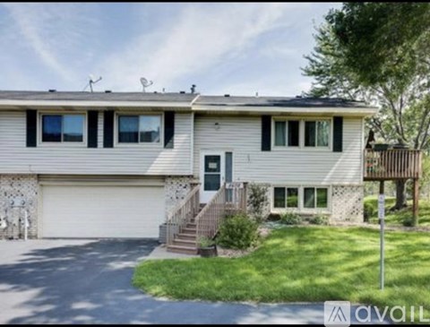 A two-story house with a garage and a front porch.