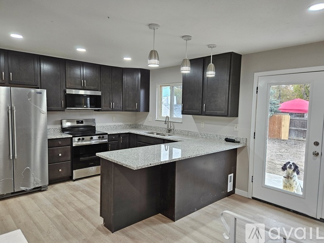 A kitchen with a refrigerator, stove, and oven.