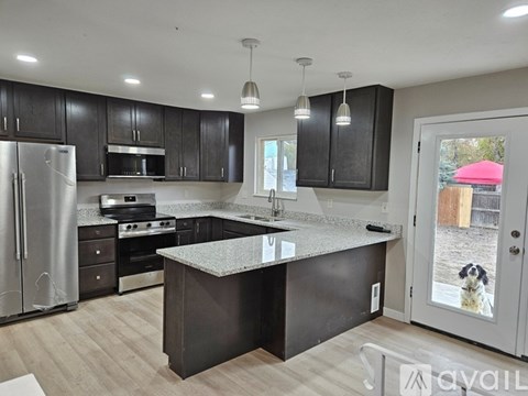 A kitchen with a refrigerator, stove, and oven.