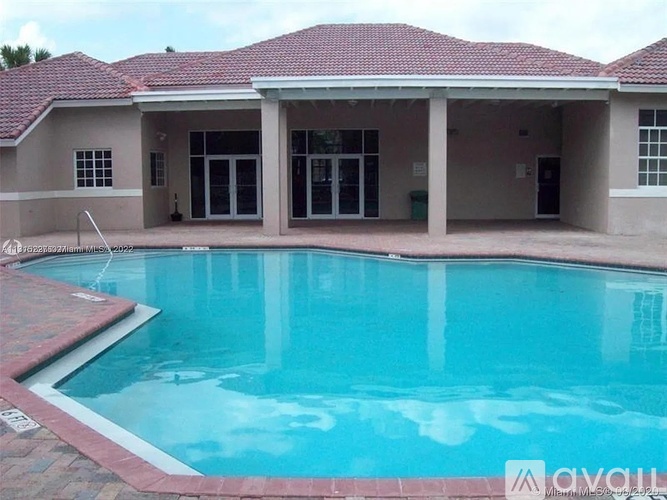 A house with a pool in front.