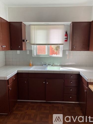 A kitchen with brown cabinets and a white countertop.